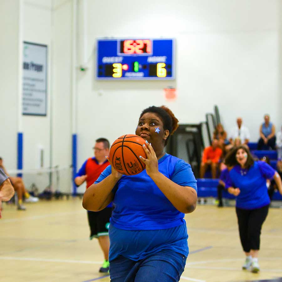 STAR participant shooting basketball playing in Basketball League | STARability Foundation