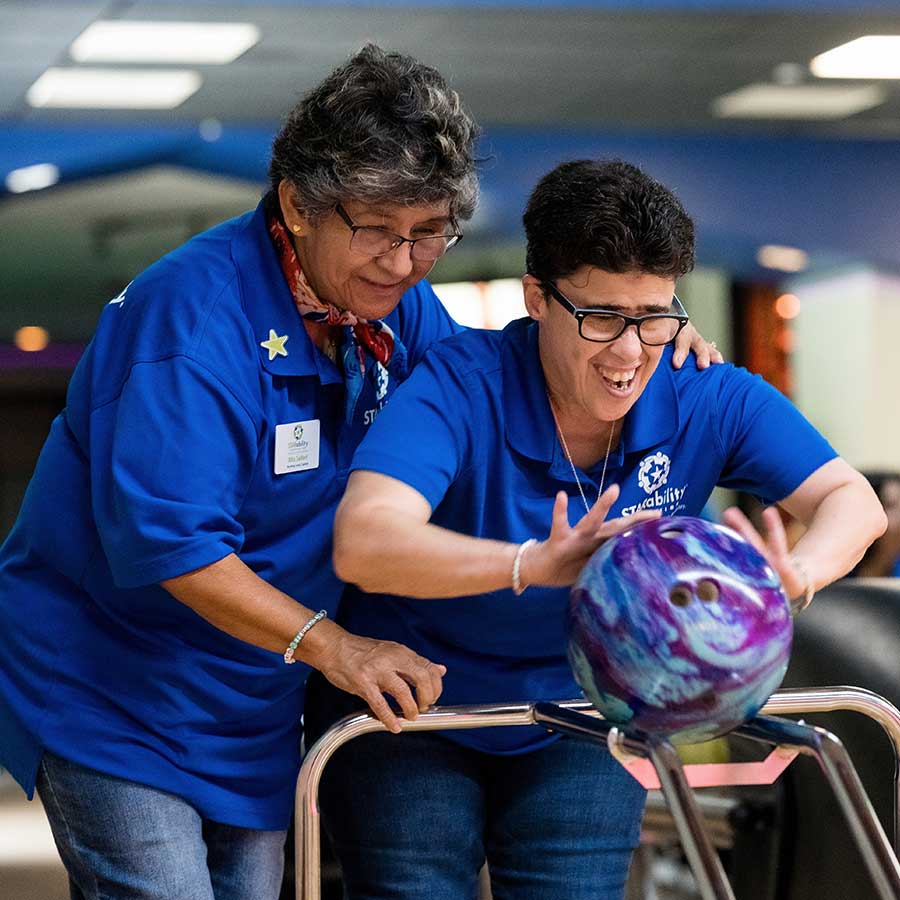 STAR instructor assisting STAR participant during bowling | STARability Foundation