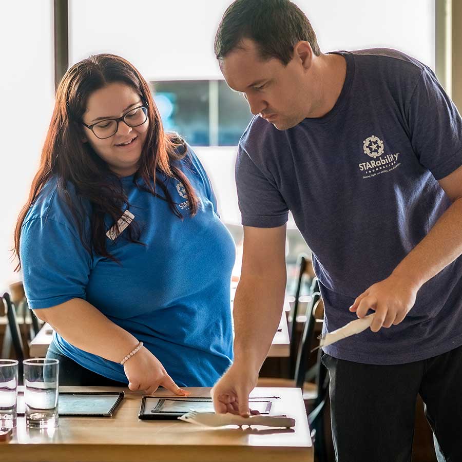 Trailblazer Academy STAR participant and instructor setting tables at MisterO1 in Naples, Florida | STARability Foundation